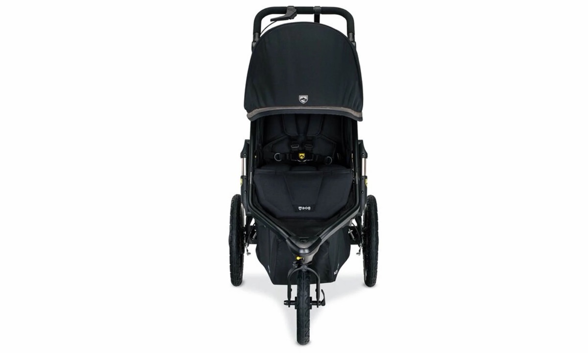 Front-facing view of the Alterrain Pro in Black showing the canopy, five-point harness and front wheel
