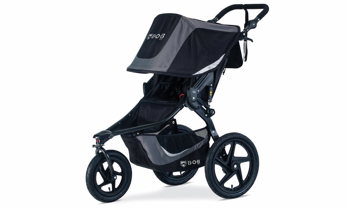 BOB Gear Revolution Flex 3.0 in Graphite Black seen from the left side, showing the seat, canopy and rear 16-inch air-filled wheel