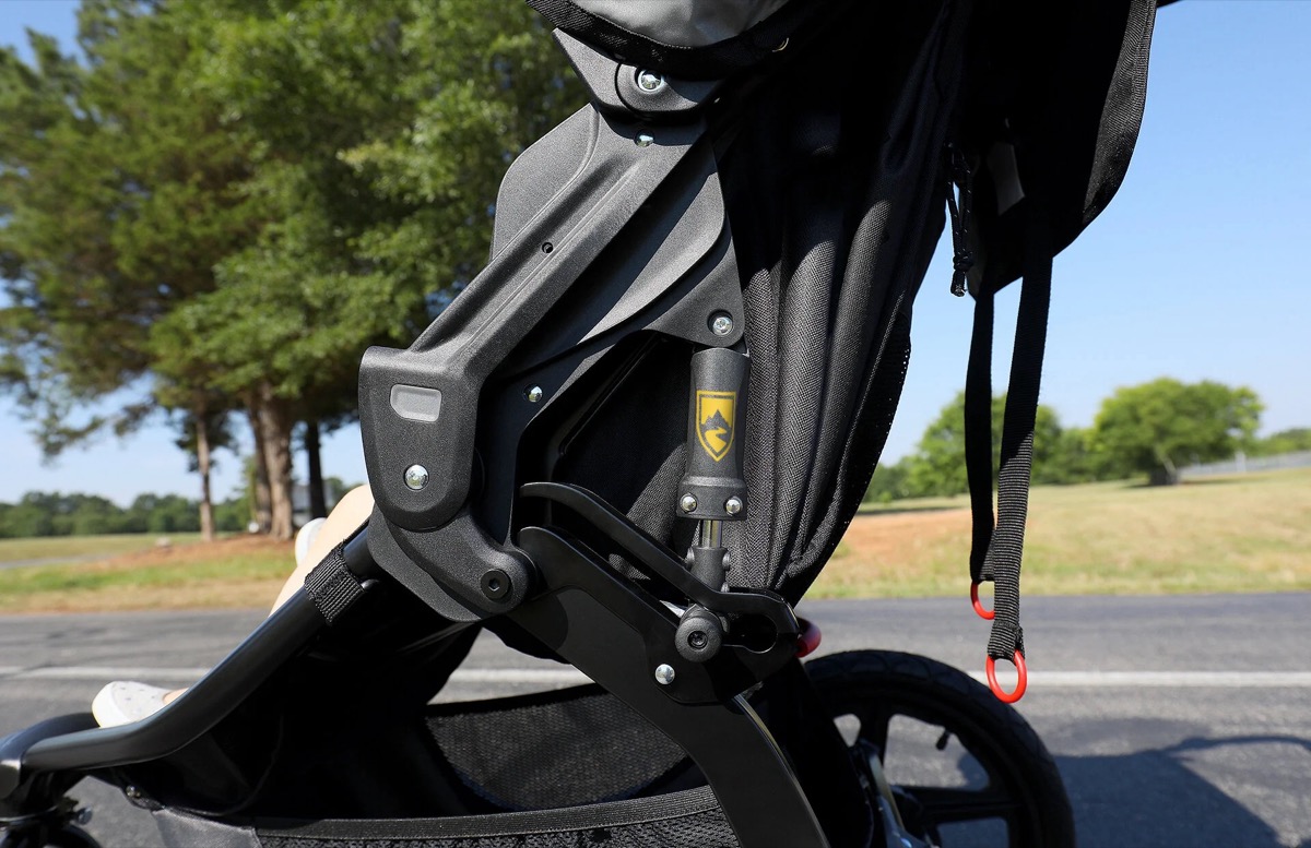 Close-up of the Revolution Flex 3.0 mountain-bike style suspension shock mounted beside the seating area on the black frame