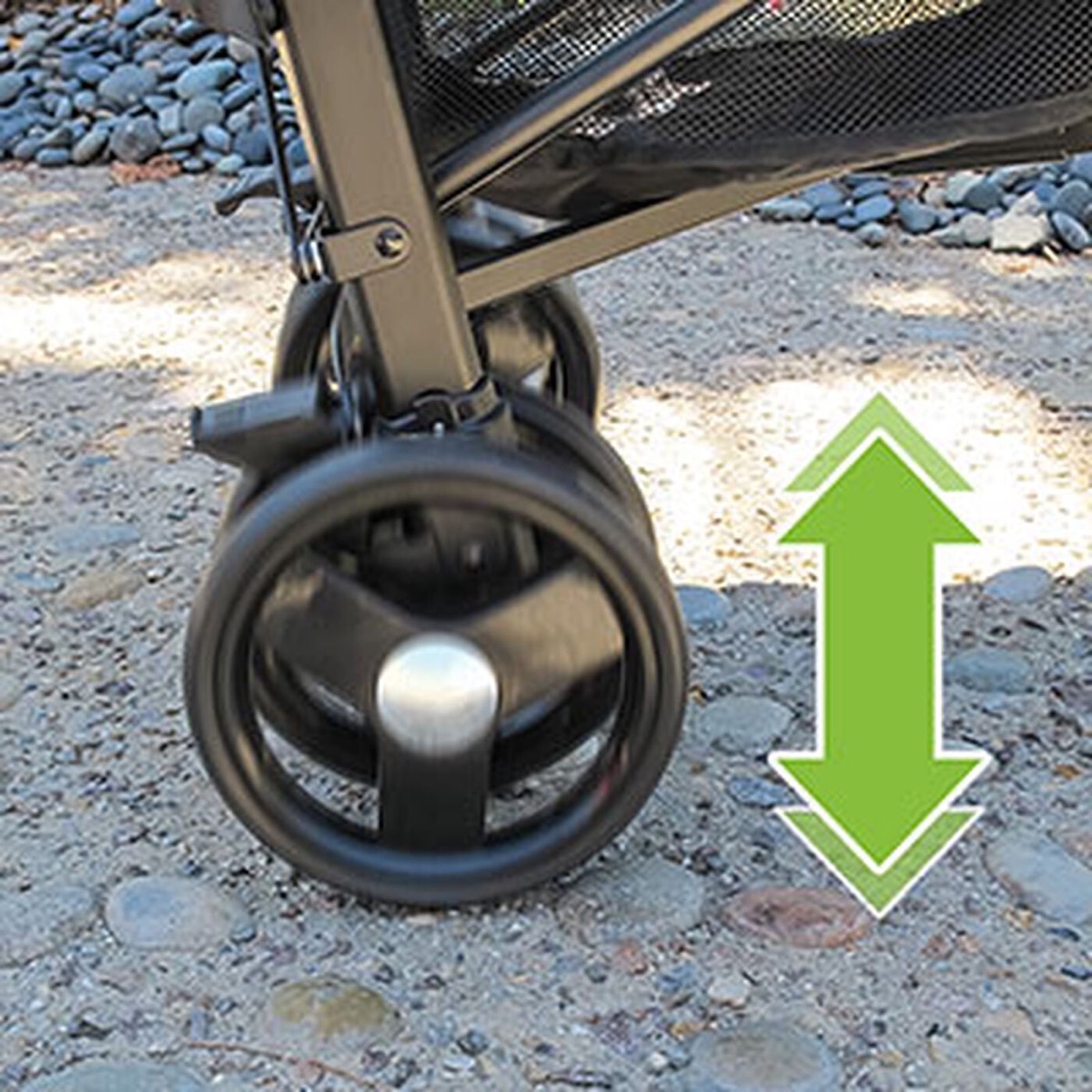Chicco Liteway stroller in motion on uneven ground, showing the rear-wheel suspension and larger rear wheels
